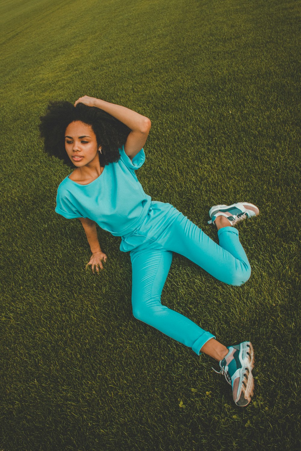 unknown person sitting on green grass field