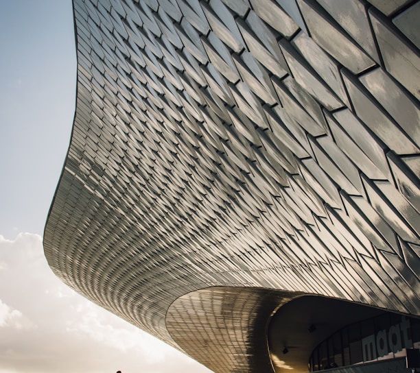 two person standing beside gray structure