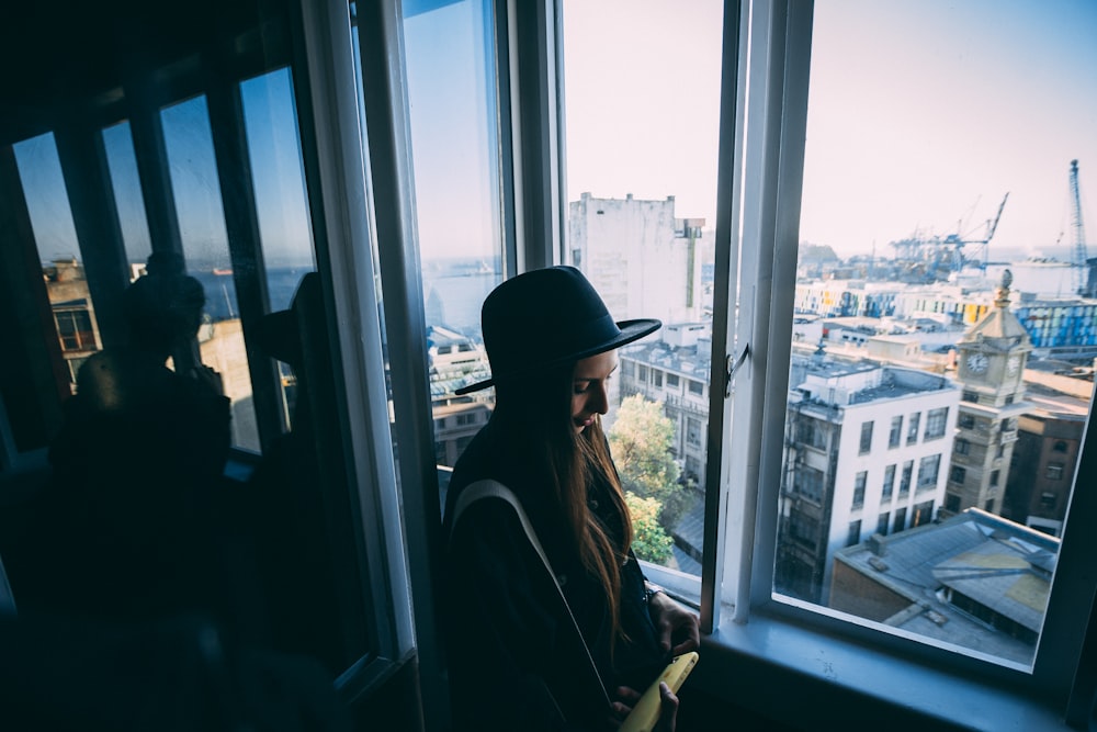 unknown person standing near glass window