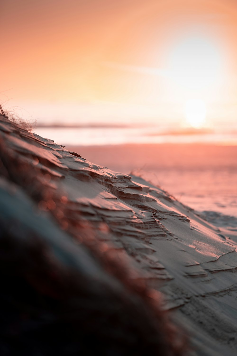 the sun is setting over the ocean with waves