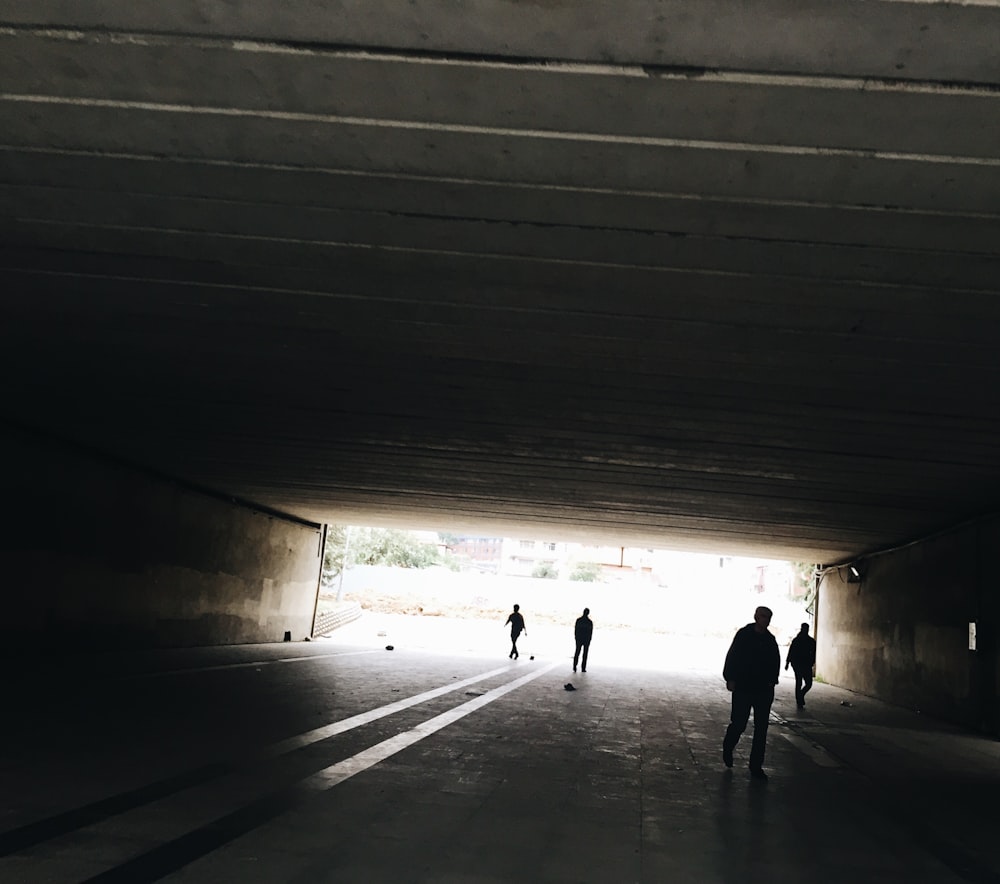 silhouette of person standing on tunnel