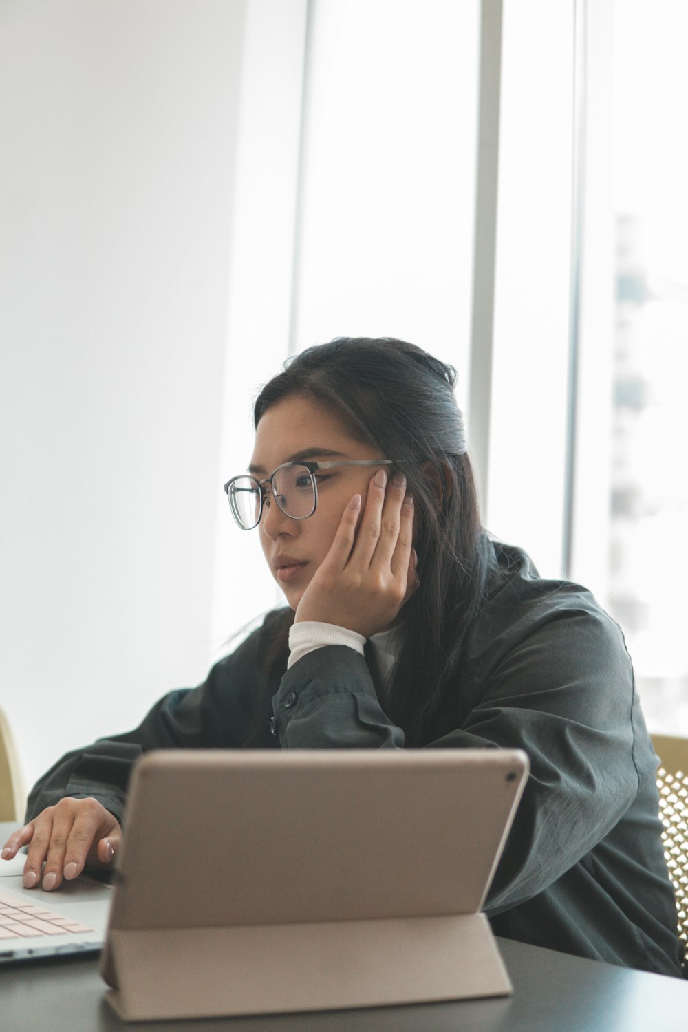 woman in black jacket using a laptop