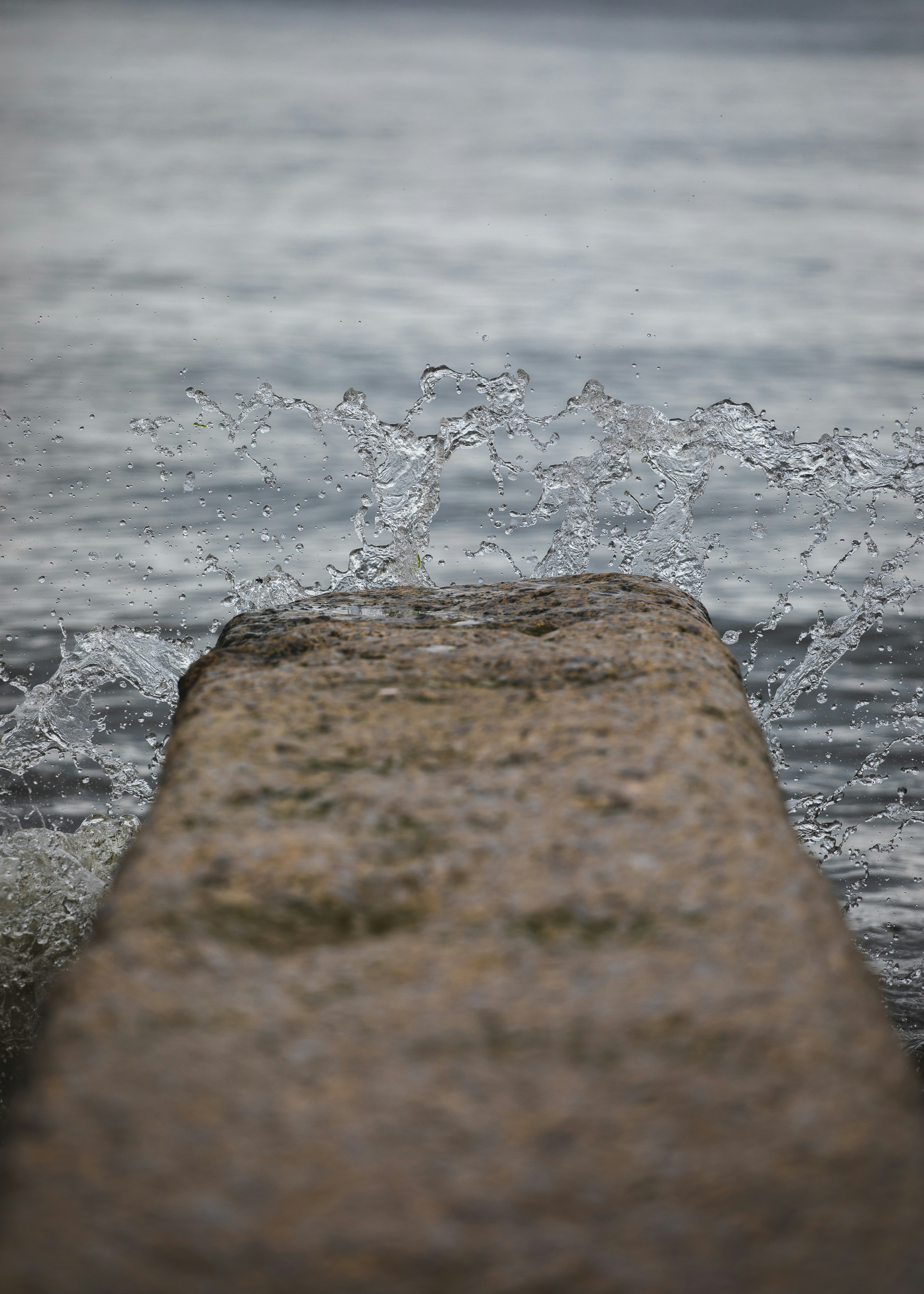 brown rock near body of water