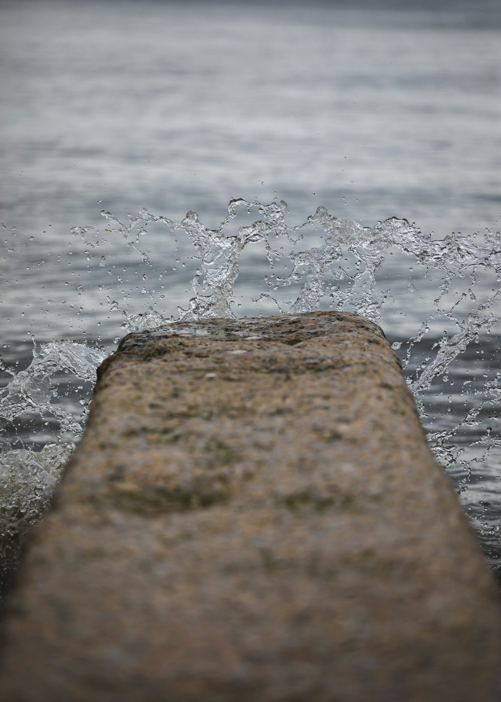 brown rock near body of water