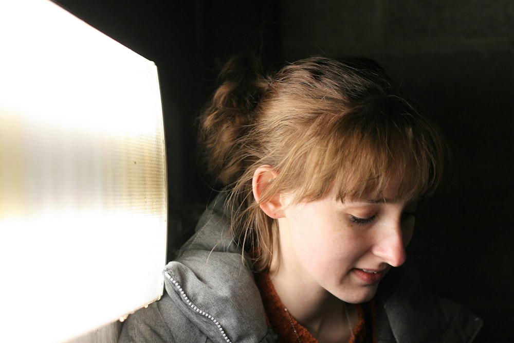 woman in grey hoodie in room