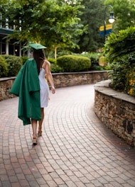 unknown person wearing academic dress walking outdoors