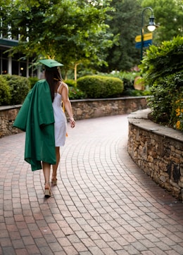 unknown person wearing academic dress walking outdoors