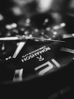 Close-up of a sleek, modern watch face with glowing digital numbers against a dark background