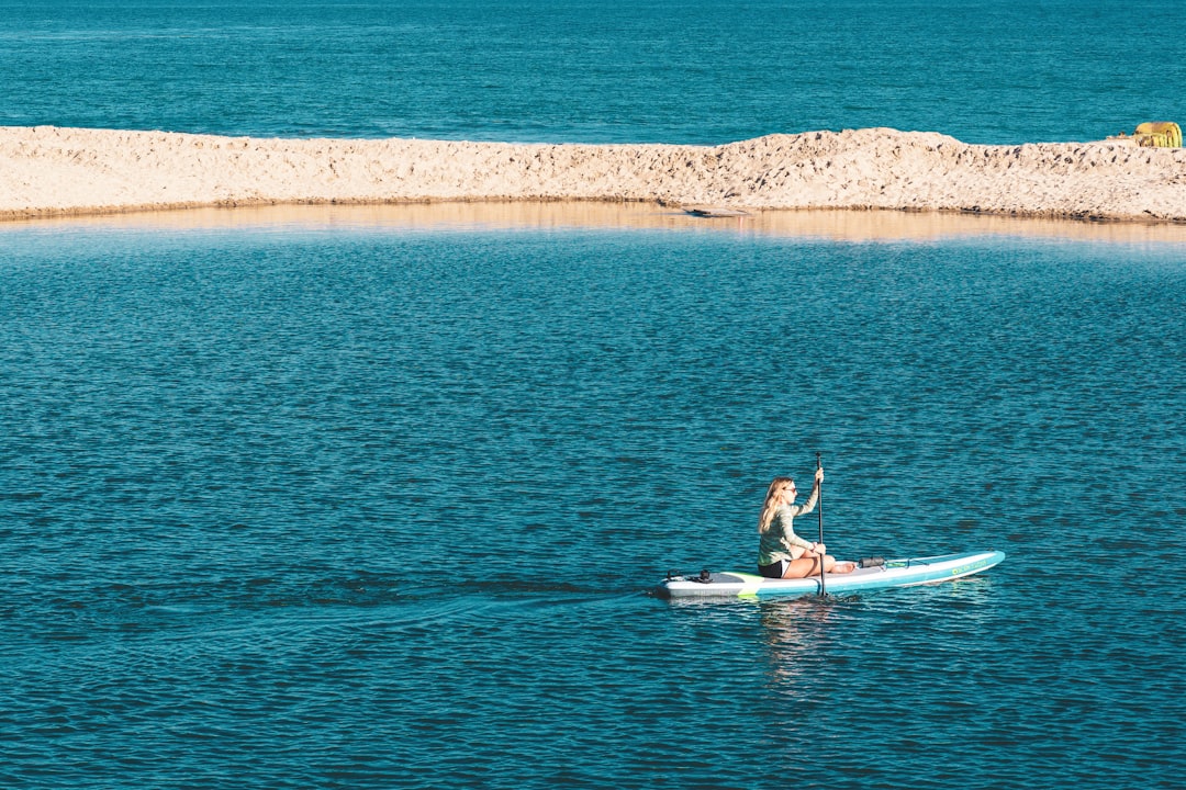 woman on a canoe rowing at the sea