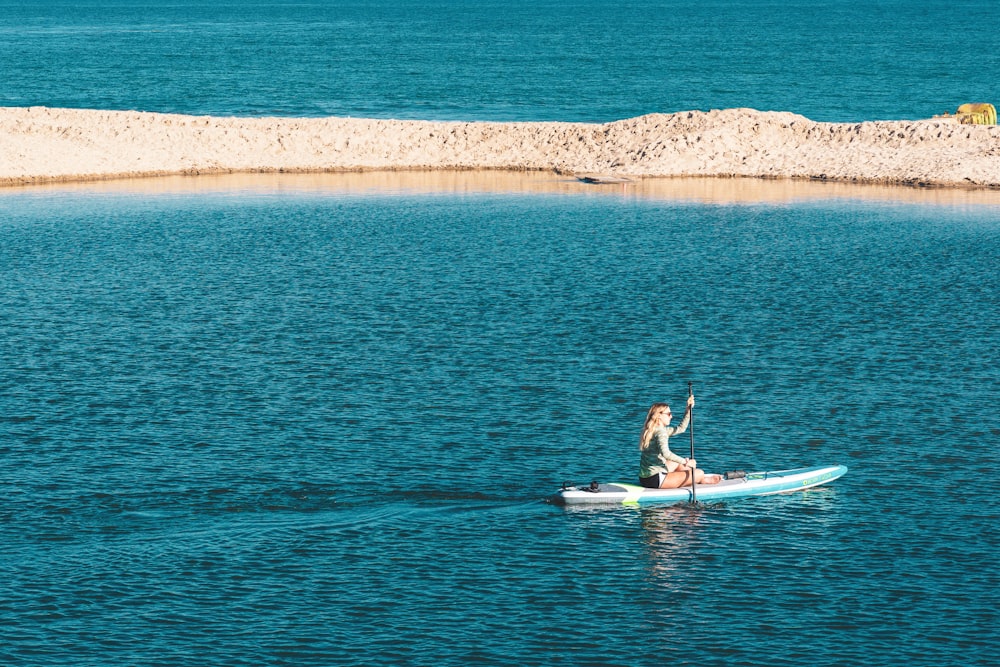 woman on a canoe rowing at the sea