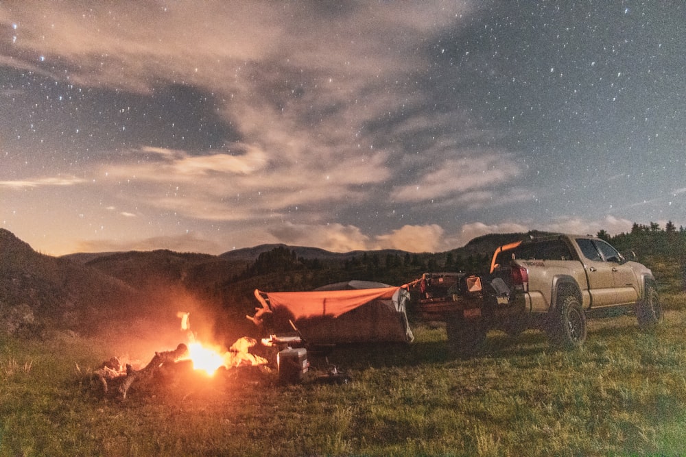 brown pickup truck beside brown camping tent