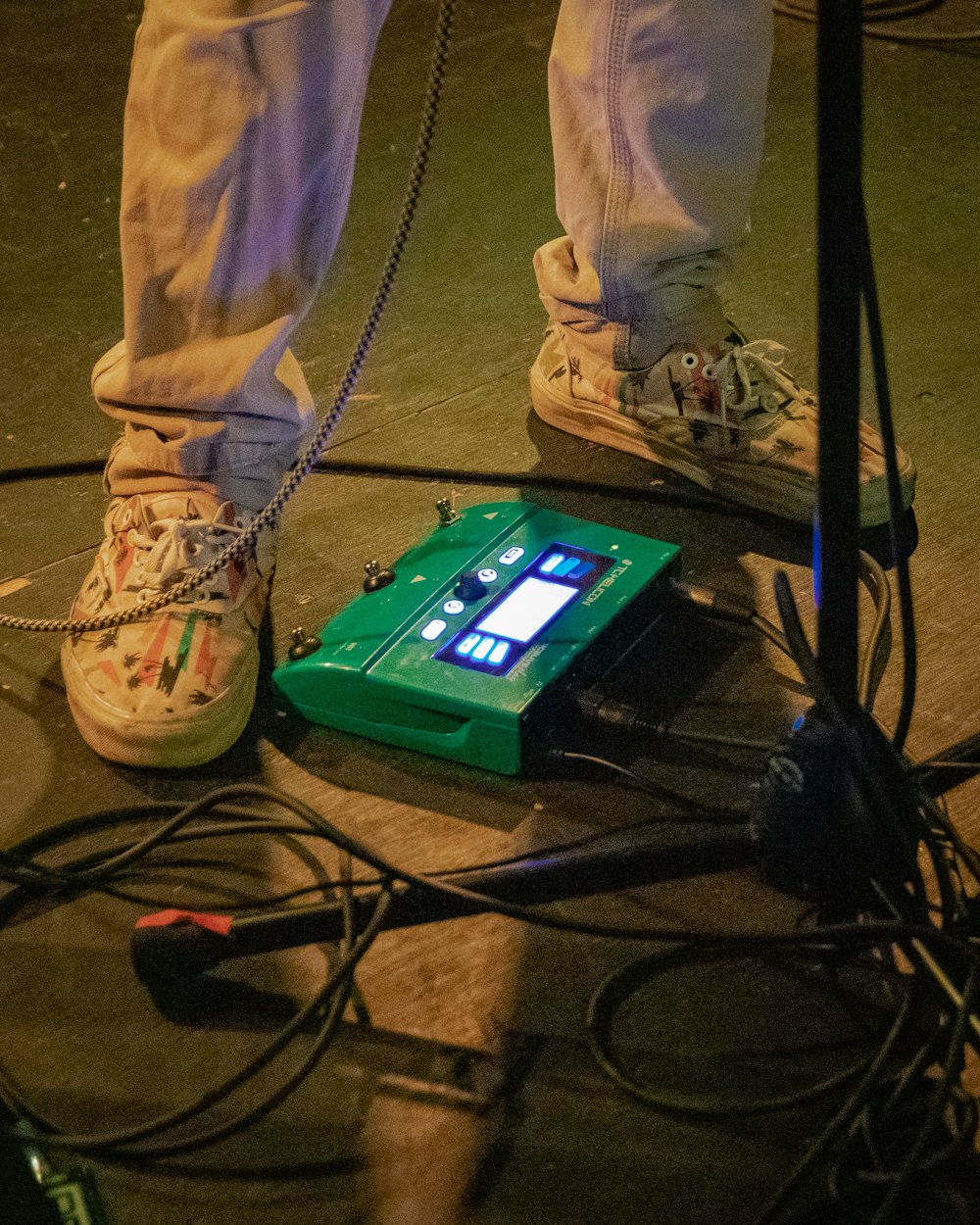 person in gray pants wearing gray low-top sneakers