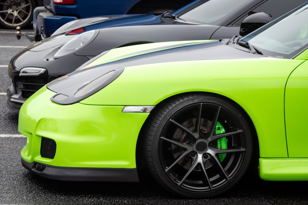 green car parked black car