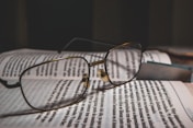 grey framed eyeglasses on book page