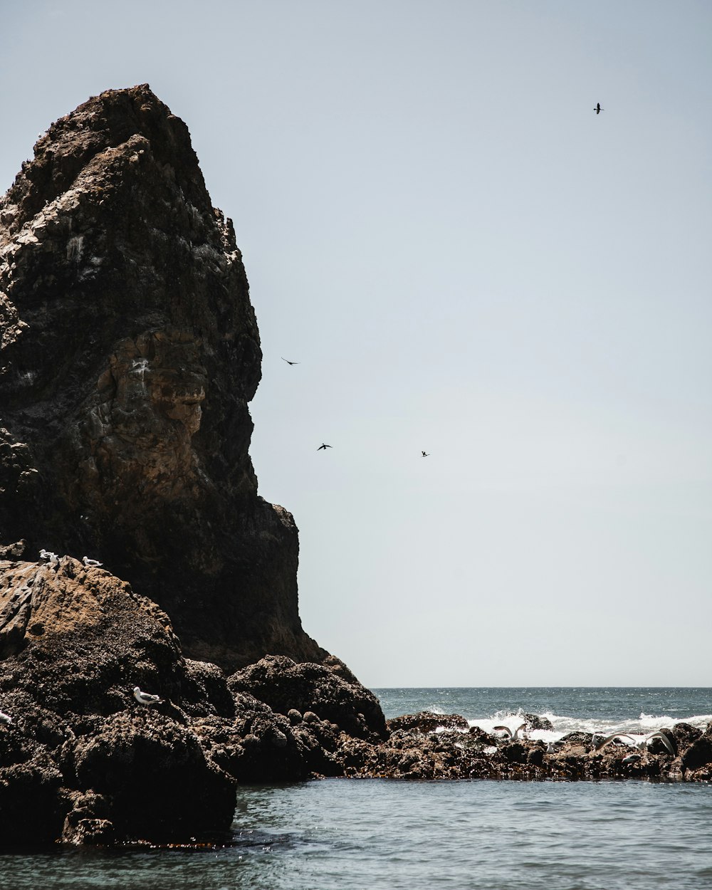 rocky island and ocean during day