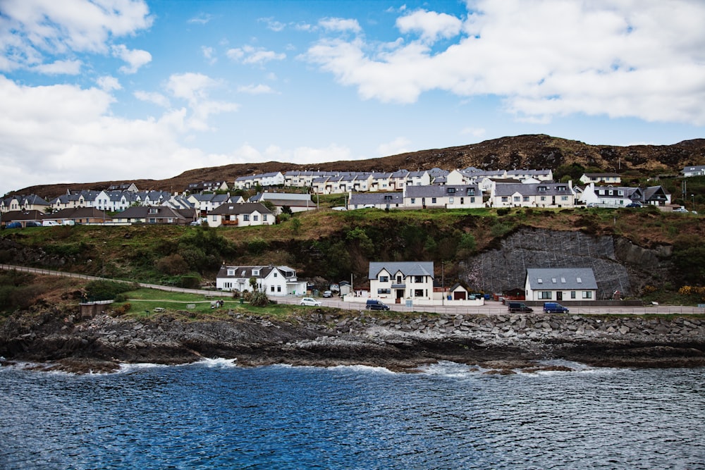 houses beside body of water during daytime