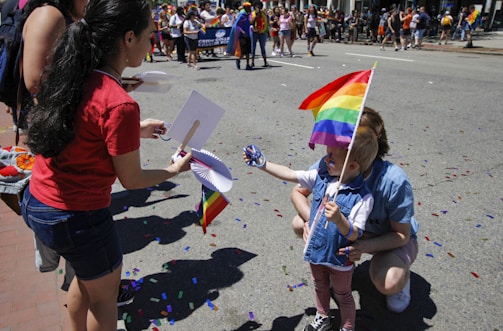A smiling child holding a handmade 'esophageal atresia alliance' banner at a community event in Israel.
