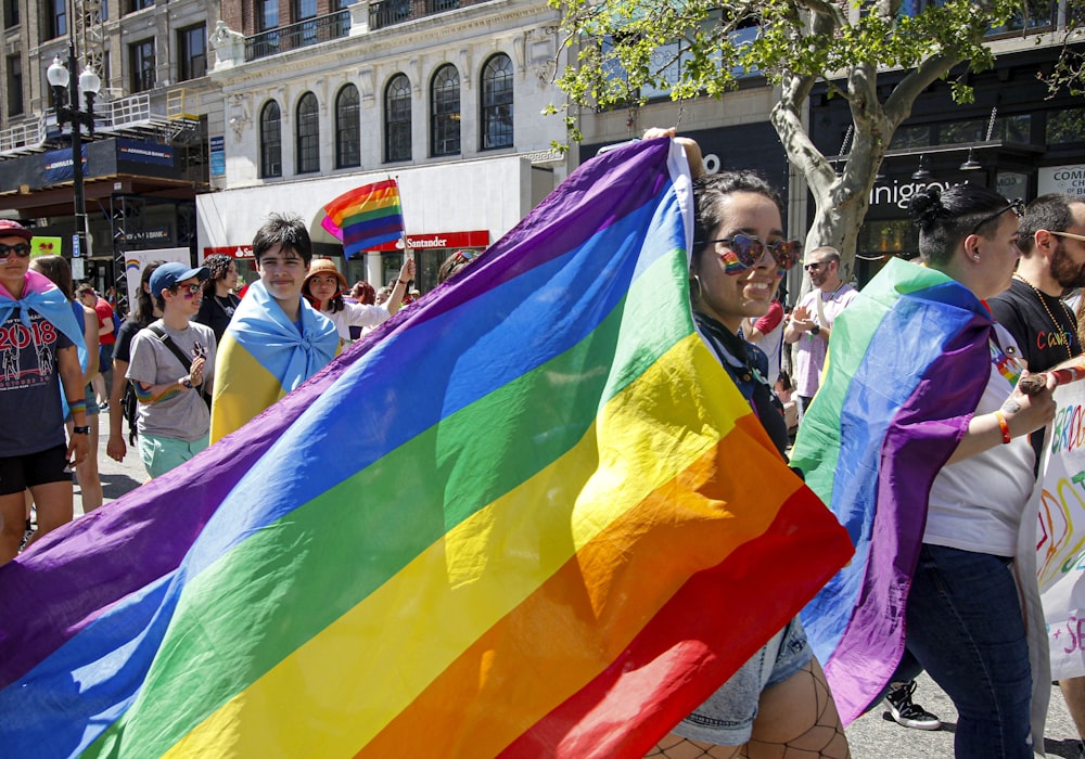 person holding multicolored flag