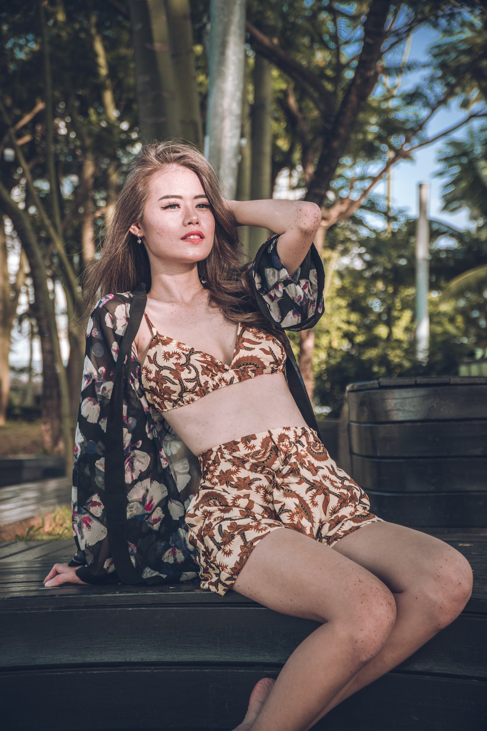 woman wearing brown floral bra holding hair