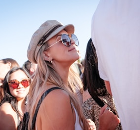 woman in white tank top smiling while standing next to person in white t shrit