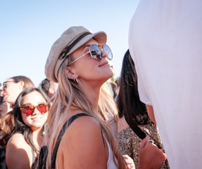 woman in white tank top smiling while standing next to person in white t shrit