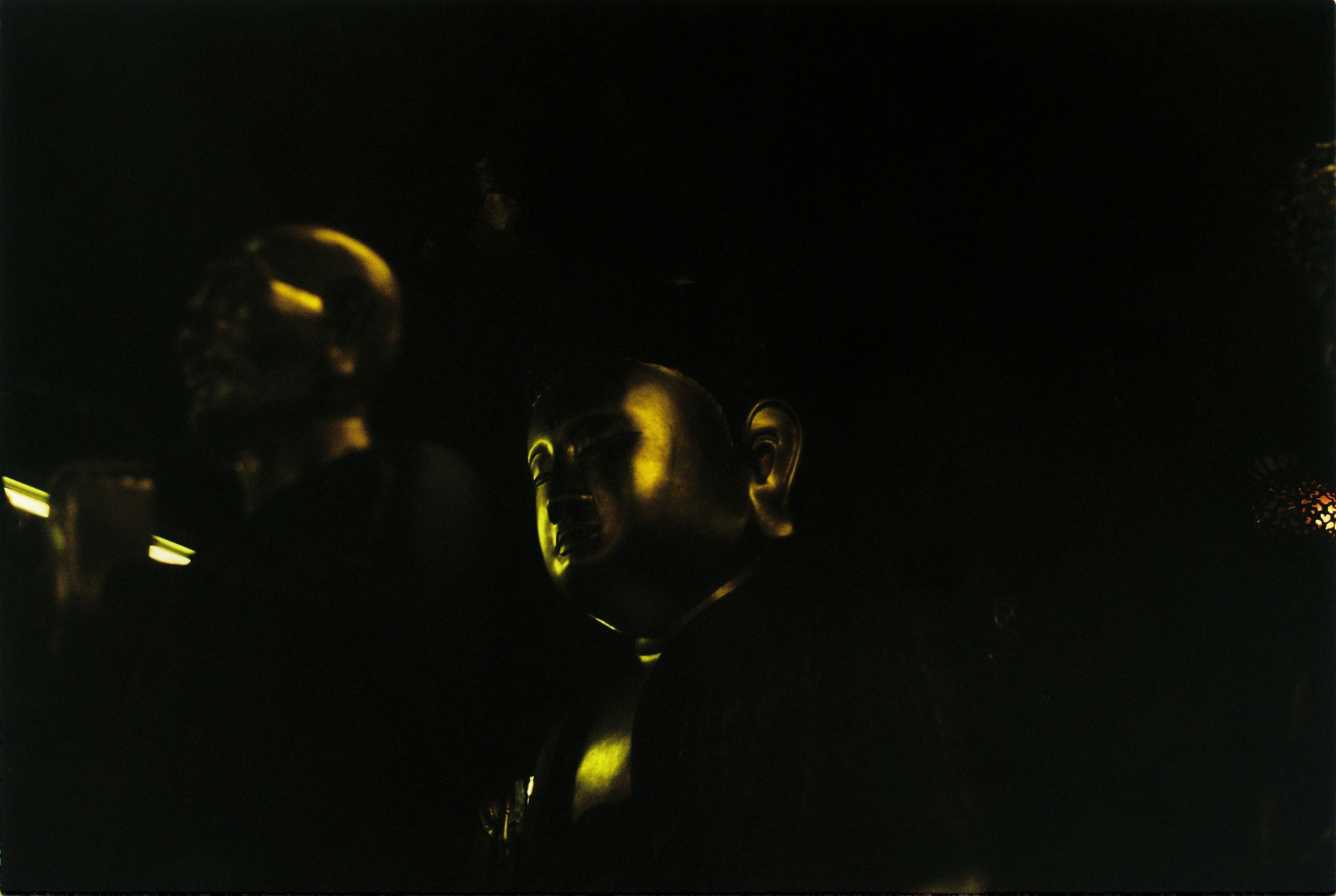 a man in a suit and tie standing in the dark