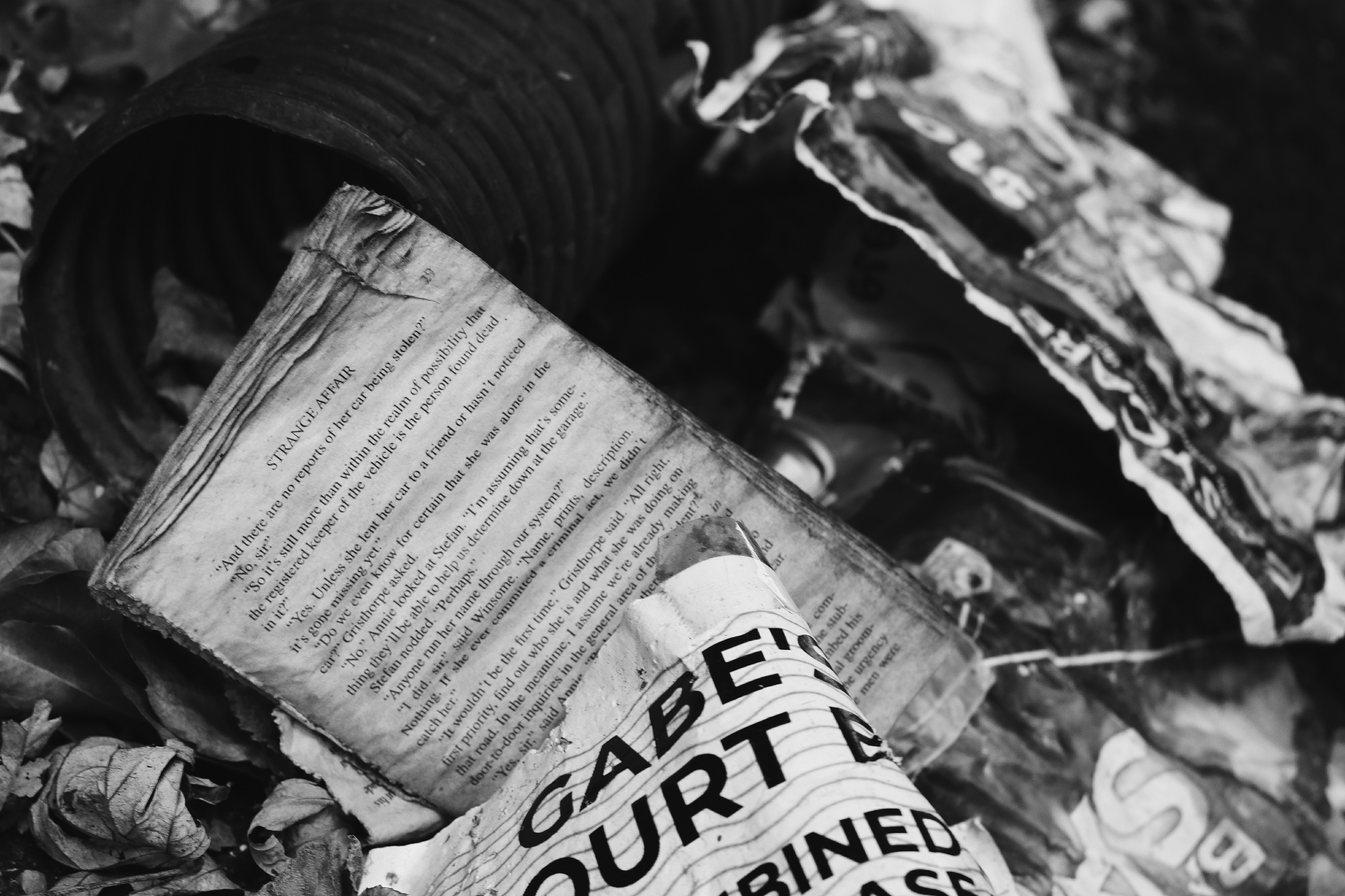 A close-up shot of a broken gavel lying on a scattered pile of official documents, with a blurred background showing signs of struggle or chaos. This symbolizes the attack on judicial authority.
