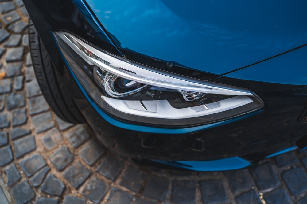 a close up of the front of a blue car