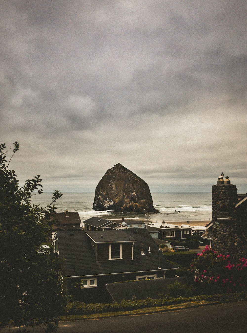 buildings near ocean under cloudy sky during daytime