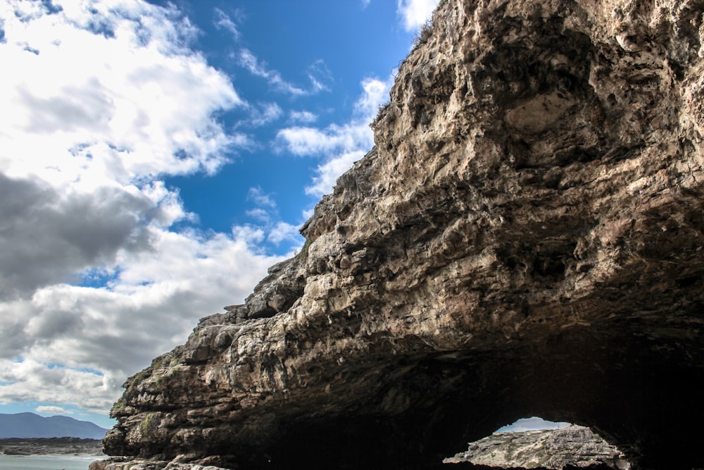 gray sea cliff under cloudy sky during daytime