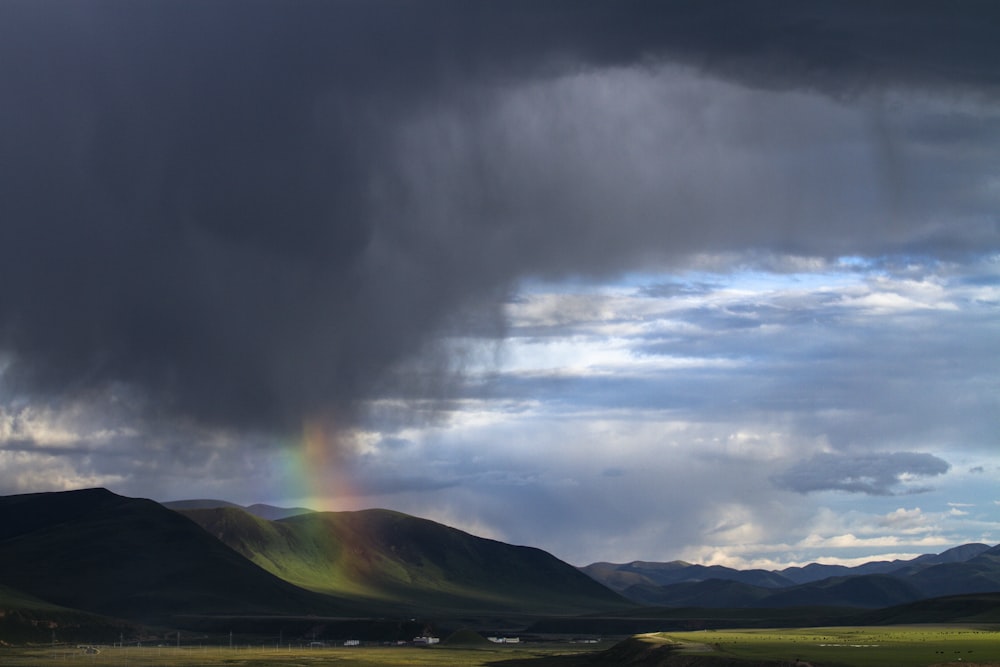 grey mountain under grey clouds