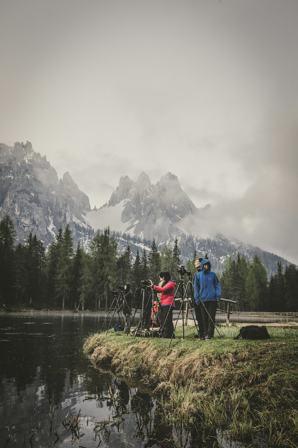 unknown persons standing near body of water