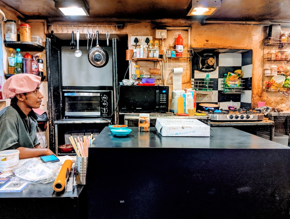 a man sitting at a counter in a kitchen
