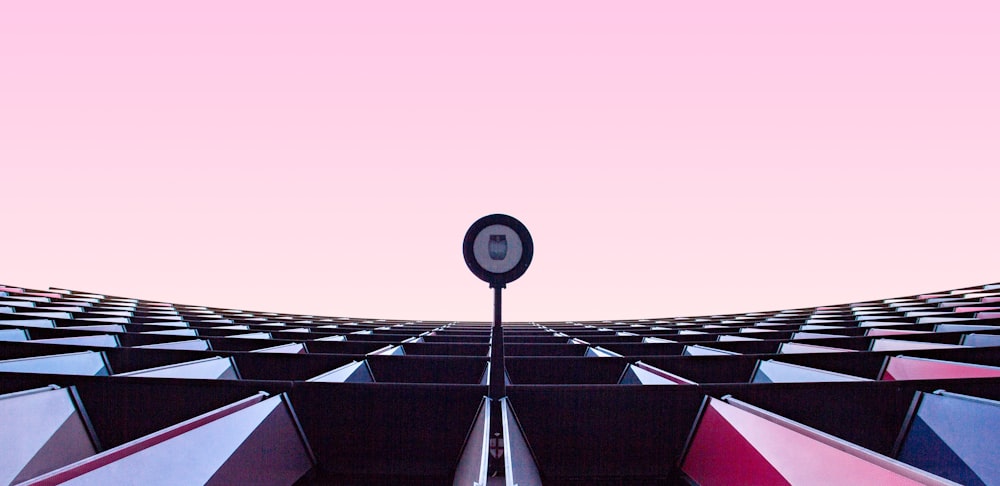 a street light in front of a pink sky