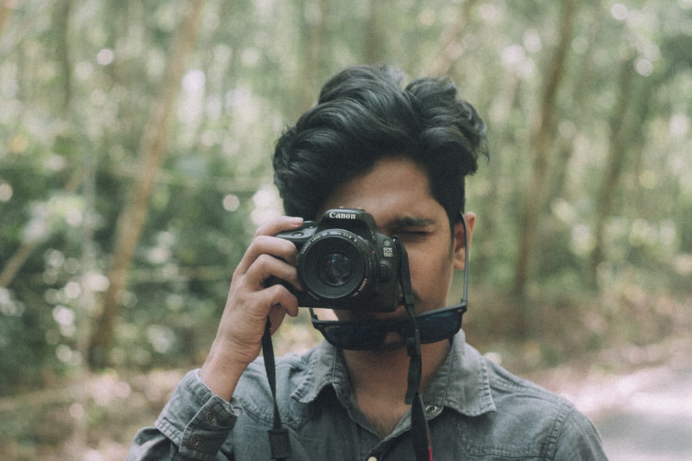 man holding DSLR camera