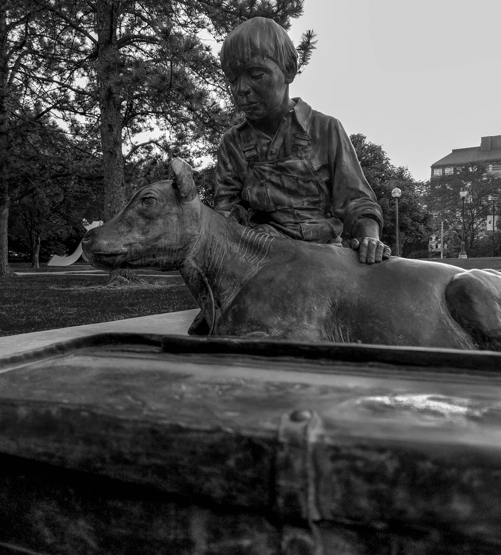 man holding animal statue