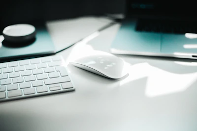 A serene workspace featuring velora research materials and a sleek laptop on a clean white desk.