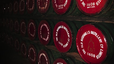 a row of wine barrels with labels on them