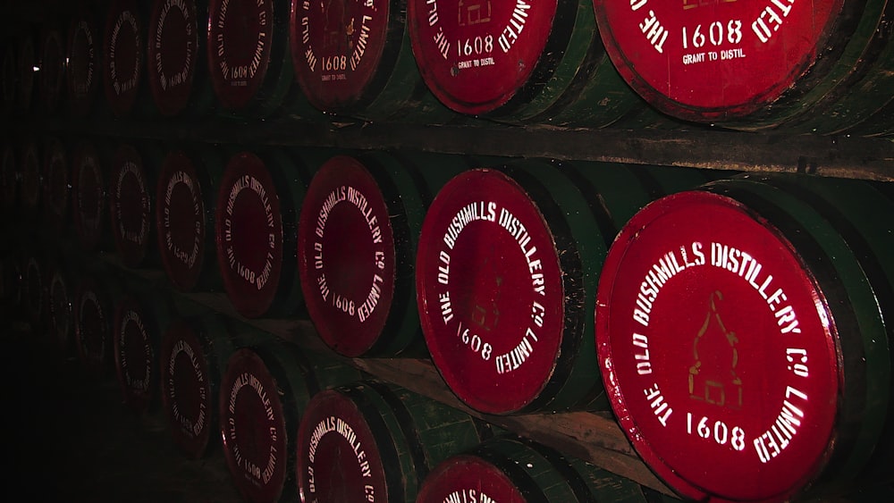 a row of wine barrels with labels on them