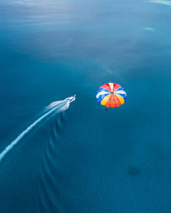 aerial photo of parachute above sea