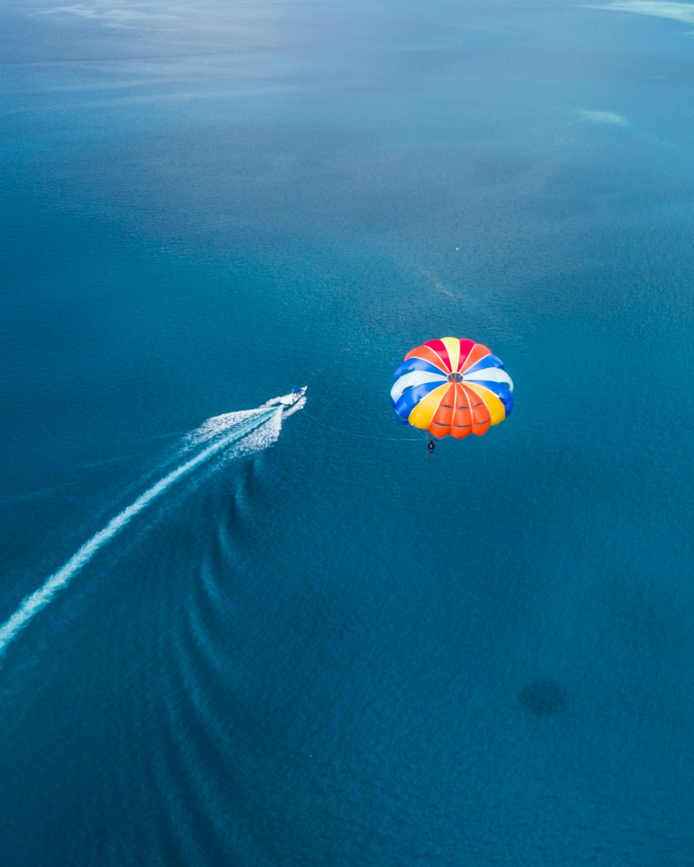aerial photo of parachute above sea