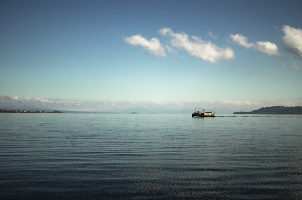 a boat floating on top of a large body of water