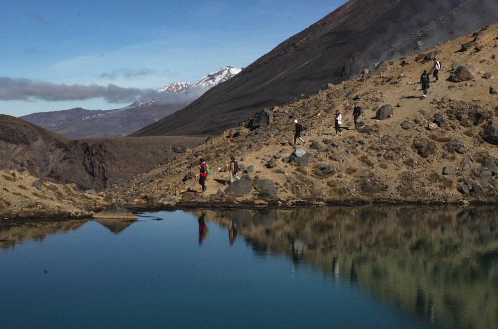 people walking near lake