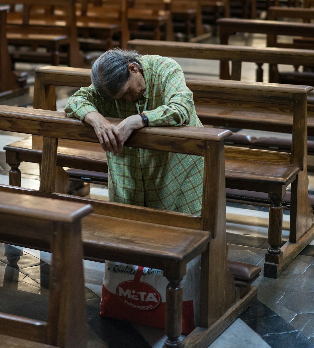 unknown person kneeling on church chair