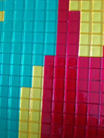 Close-up of various colorful floor tiles arranged in a creative pattern.