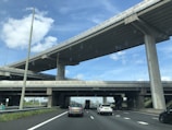 A panoramic view of the Kolam Interchange bustling with traffic under a clear blue sky.