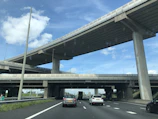 A completed highway interchange bustling with traffic under a clear sky.