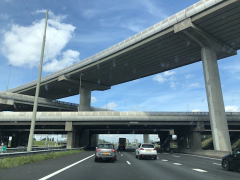 A completed highway interchange bustling with traffic under a clear sky.