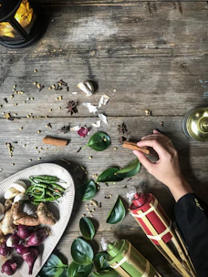 Close-up of fresh tropical fruits and local spices arranged beautifully on a rustic wooden table.