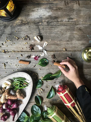 Close-up of fresh tropical fruits and local spices arranged beautifully on a rustic wooden table.